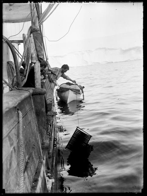 #18 Frank Hurley washing cinematograph film on the “Aurora”, 1912