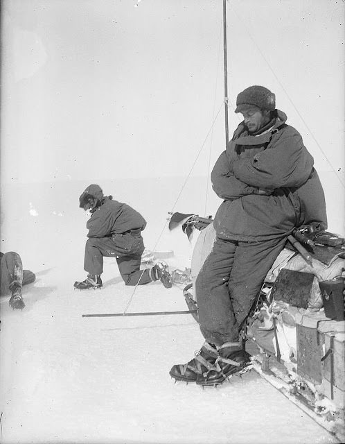 #21 Mawson rests at the side of sledge, outward bound on first sledge journey in Adelie Land, 1912