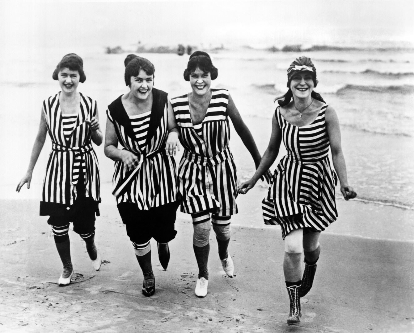 #13 Four young women in matching beach wear run out of the surf, Los Angeles, 1910
