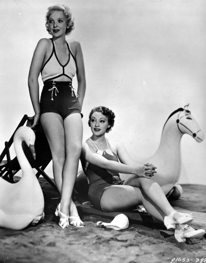 #35 Actresses Ida Lupino and Kathleen Burke model the latest swimwear, 1935