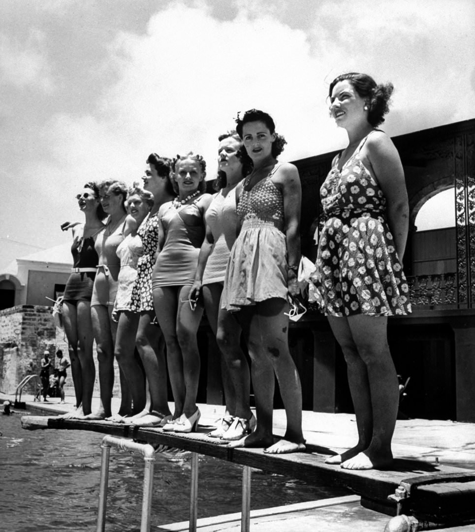 #40 Bathing suit clad female members of the British Imperial Censorship Staff,standing poolside at the Princess Hotel, 1941