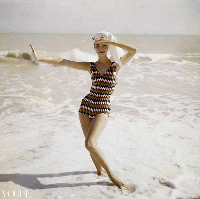 #63 Model standing on beach wearing a bathing suit in harlequin-diamond wool, 1957