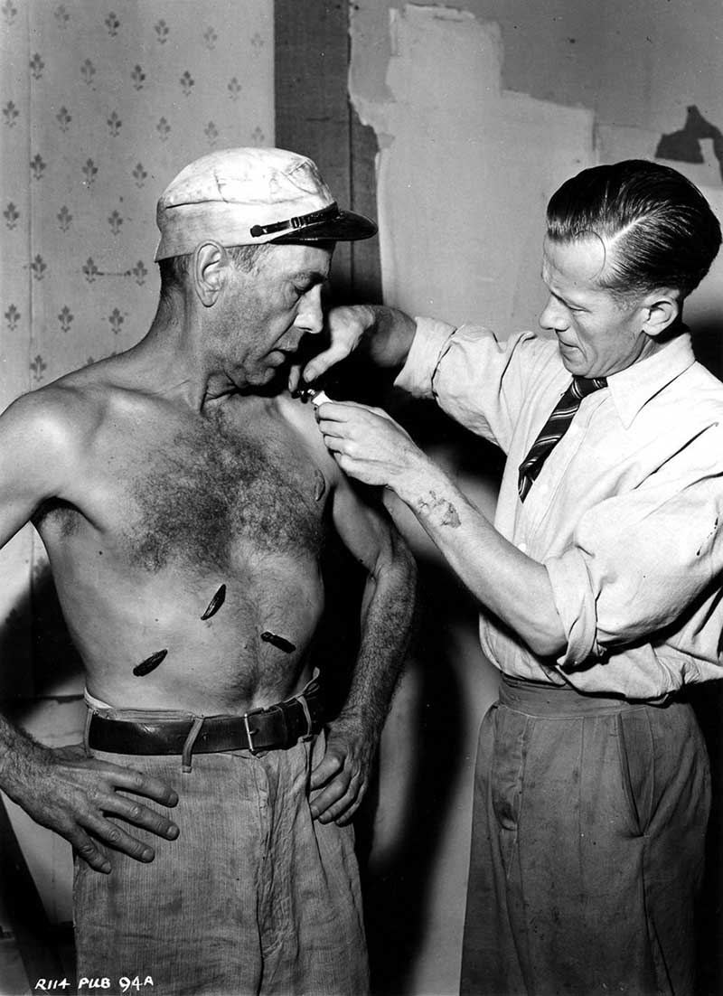 Humphrey Bogart having rubber leeches applied to his chest for the filming of “The African Queen”, 1951