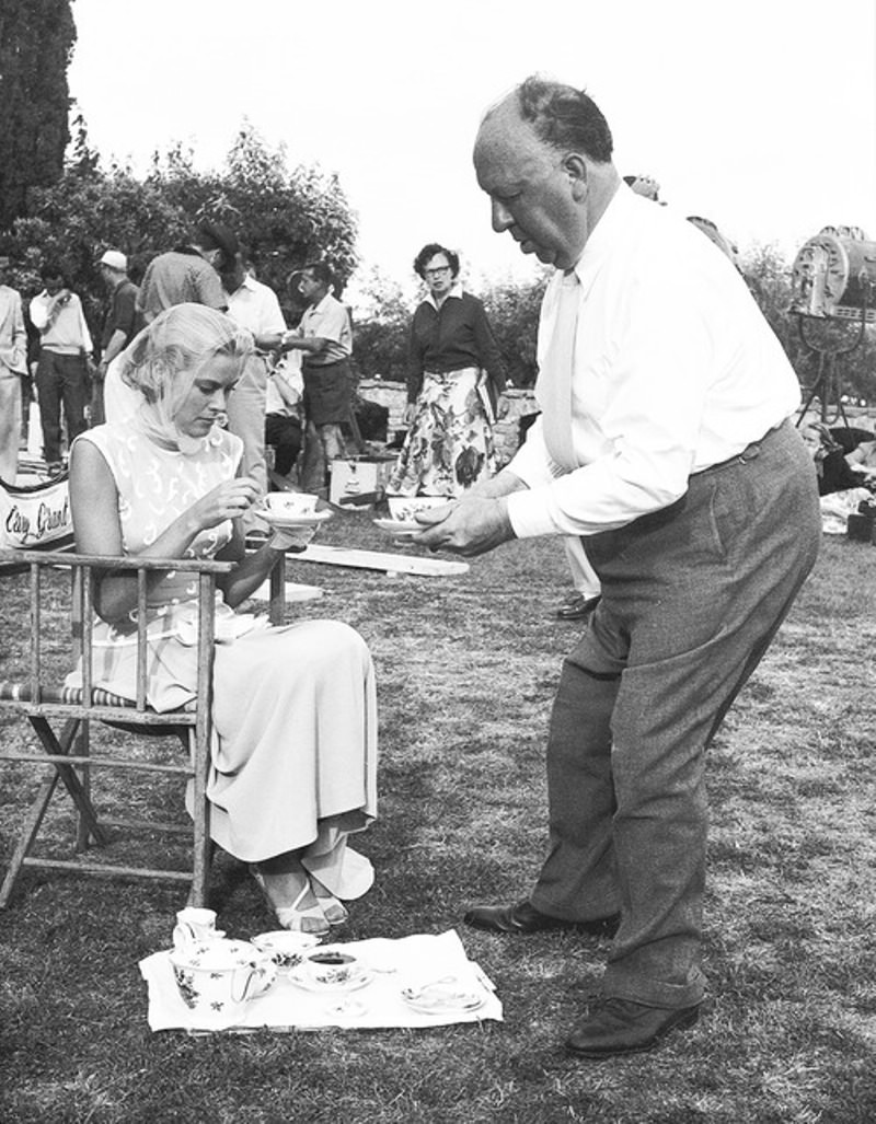 Alfred Hitchcock serving Grace Kelly tea on the set of “To Catch a Thief” , 1955