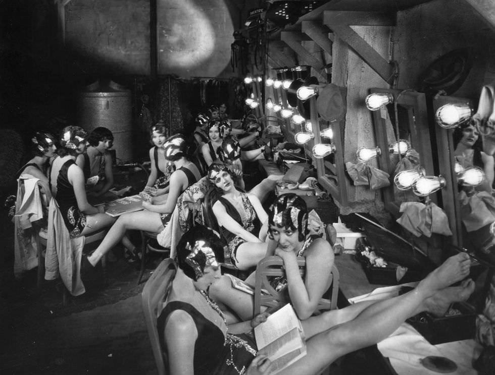 Chorus girls relaxing in the dressing room between scenes during the filming of ‘Broadway’, 1928