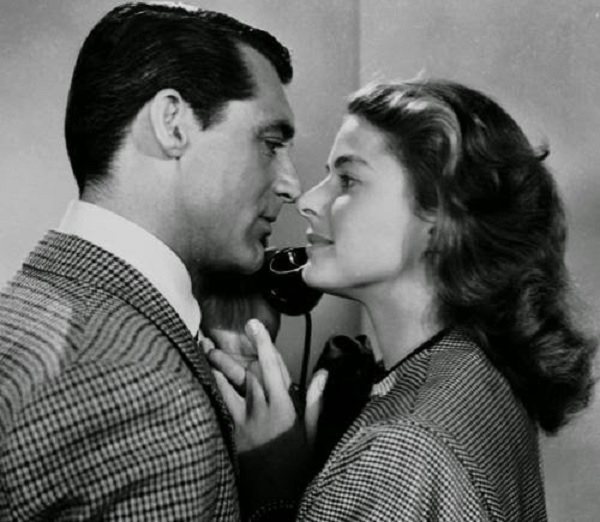 #13 Cary Grant on the phone standing with Ingrid Bergman, 1946
