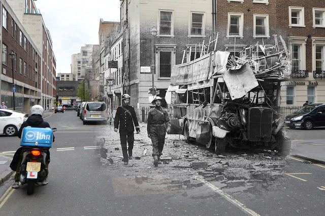 THEN: A police officer and a soldier inspecting the aftermath of a German air raid, Portman Street, London, 19th September 1940. NOW: A street scene at Portman Sreet near Marble Arch, on April 21, 2016 in London, England.