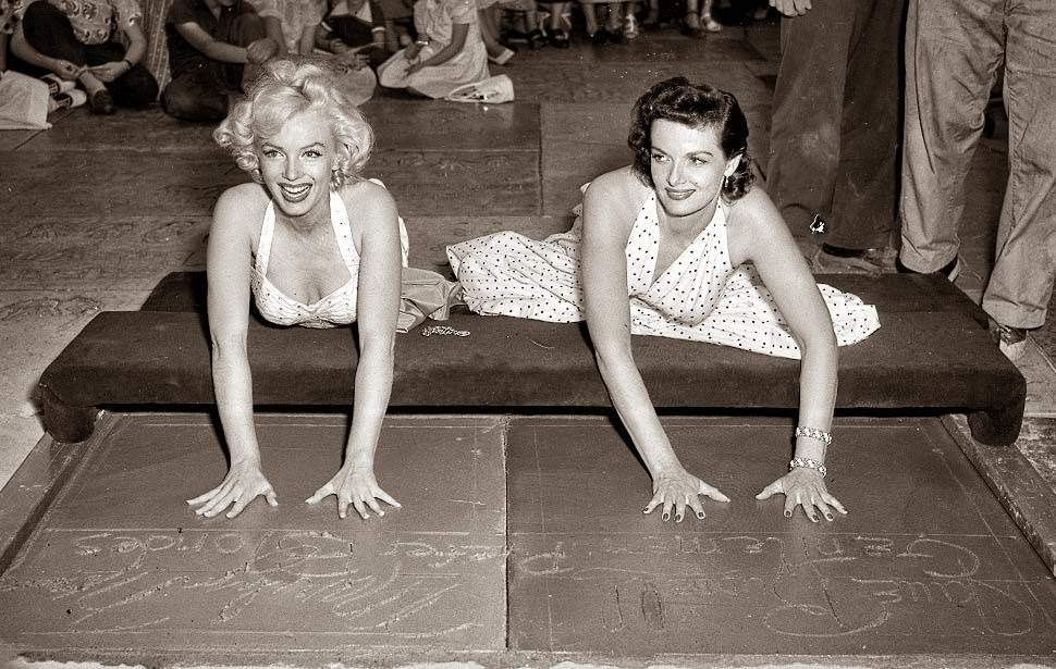 #50 Marilyn Monroe and Jane Russell placing handprints in front of Grauman’s theater, 1953