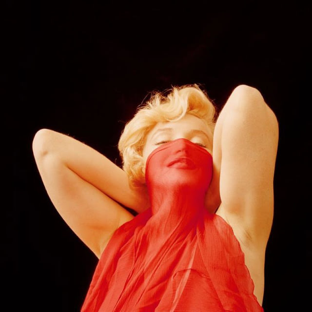 #76 Marilyn Monroe playfully poses during the ‘The Red Dress Sitting’ Series, January 1957