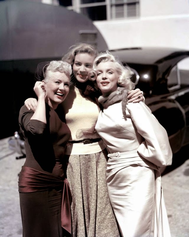 #49 Marilyn poses with Lauren Bacall and Betty Grable on the set of “How to Marry a Millionaire.”, 1953