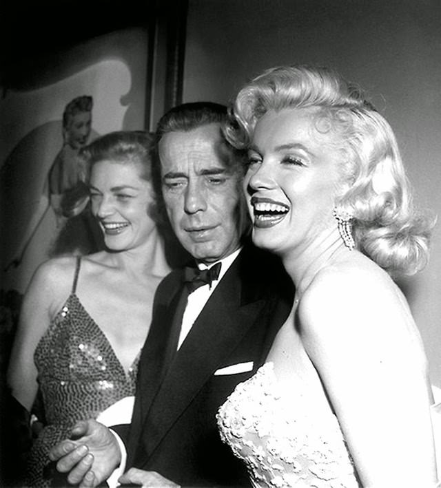#50 Marilyn with co-stars Humphrey Bogart and Lauren at the premiere of their movie, 1953