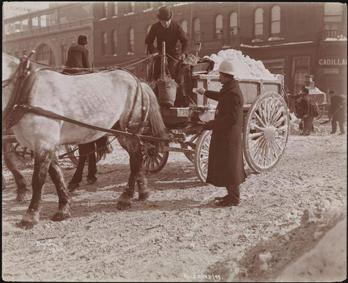 #16 A police officer handing something to a horse-cart driver hauling snow, 1899