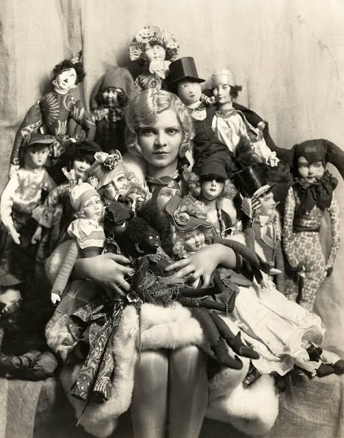 #63 A Young Woman Poses With Her Boudoir Doll Collection in Paris, France in 1922