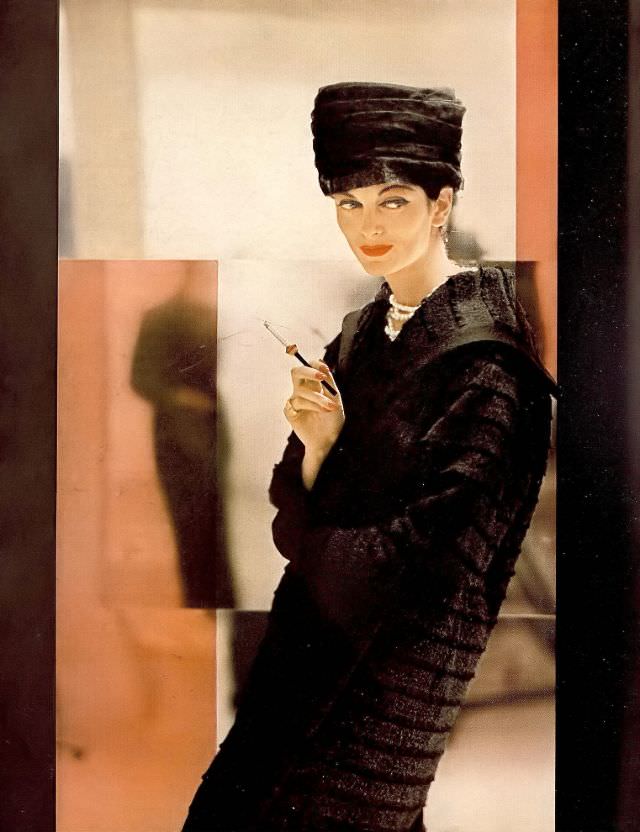 #40 Carmen in coat of clipped layers of deep black wool woven with fur by Lilli Ann, fur toque by Mr. John, 1956.