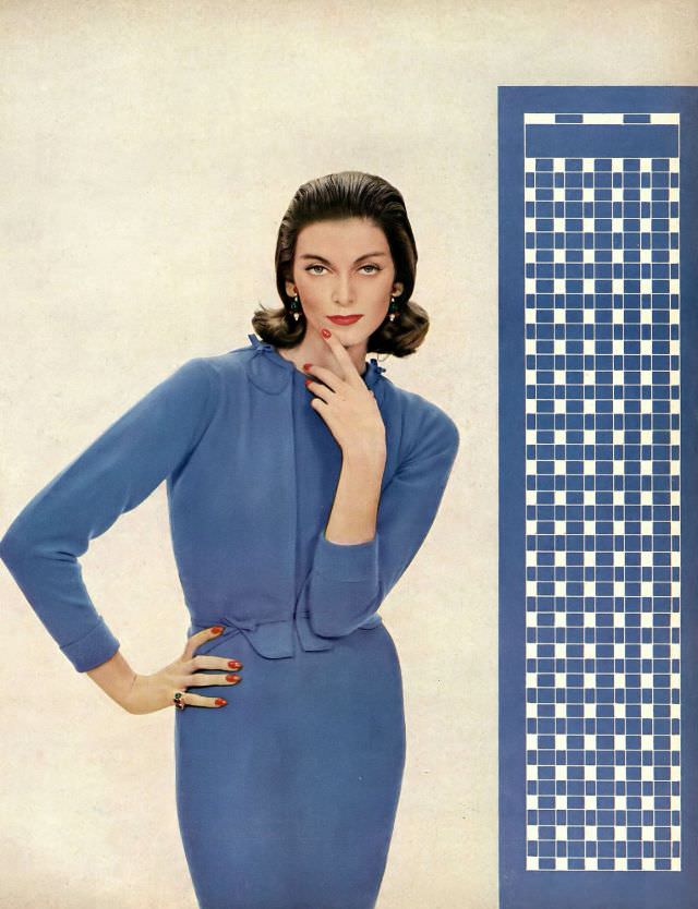 #44 Carmen Dell’ Orefice in soft blue cashmere cardigan scrolled in appliqué over a matching short-sleeved dress in thin blue wool by Vera Stewart, Harper’s Bazaar, 1957.