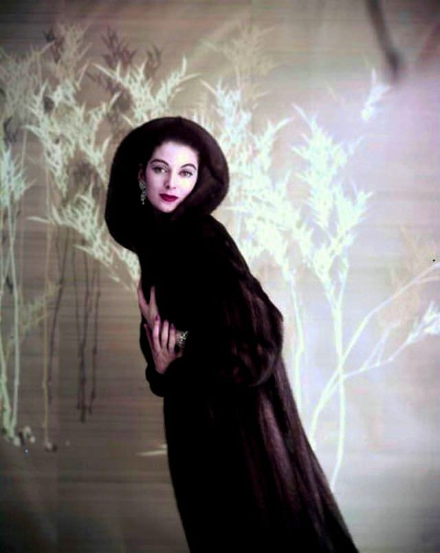 #46 Carmen in a dark hooded mink coat, 1957.