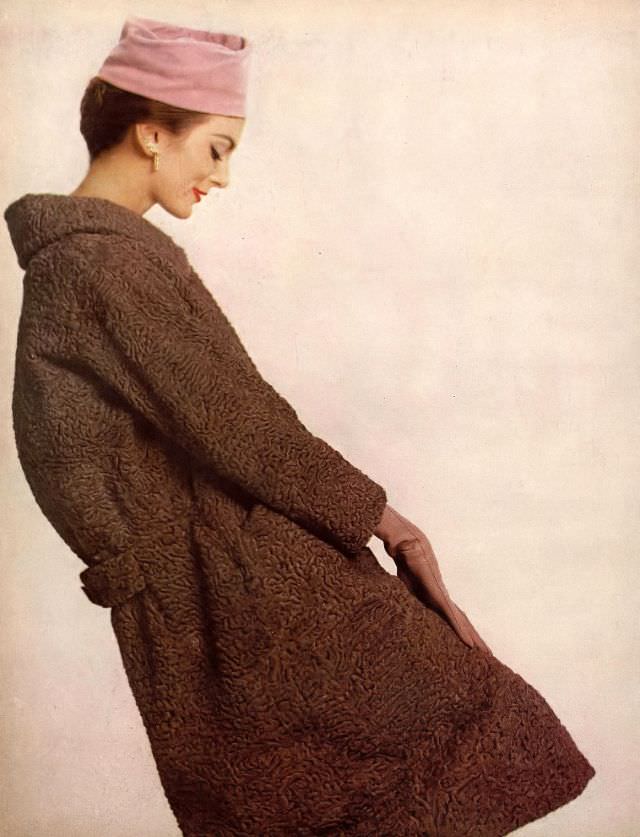 #52 Carmen in mocha-colored Persian lamb walking coat by Schiaparelli, hat by Mr. Arnold, jewelry by Verdura, 1958.