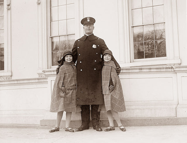 #7 Twin girls posing with a police officer