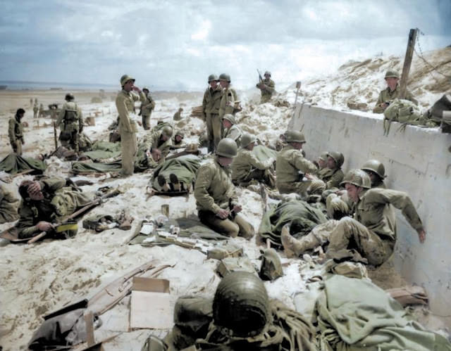 #17 US Army Fourth Infantry Division troops take a breather after making their way onto Utah Red Beach.