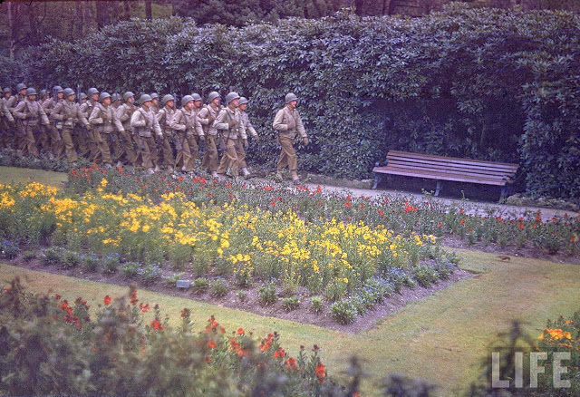 #61 American infantrymen marching in an unident. park in England shortly before D-Day.