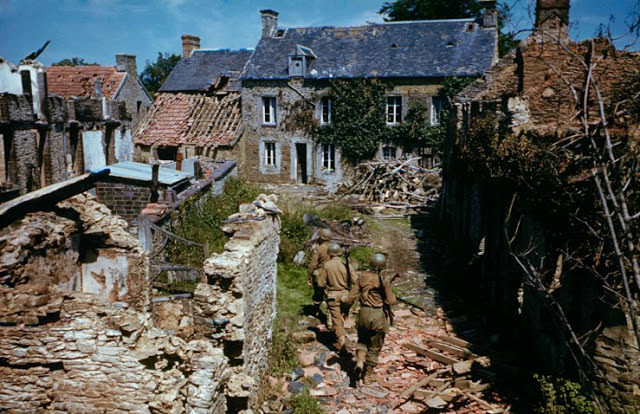 #25 Troops searching ruined homes in western France after D-Day.