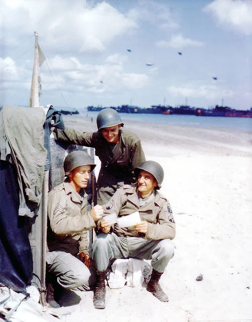 #49 Operation Overlord Normandy, Three American soldiers from the 1st Engineer Special Brigade are looking at photos from home.