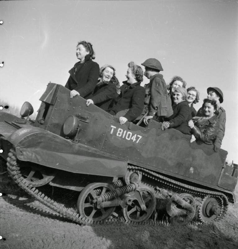 #22 Women war workers from J & F Pool Ltd, a small West Country arms factory, travel to a test range in a Universal carrier, Mark I, 1943.