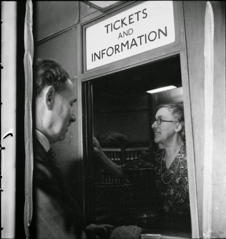#24 Rose Pillon offers advice to a passengers from the ‘Tickets and Information’ window at this London Underground station, 1942.