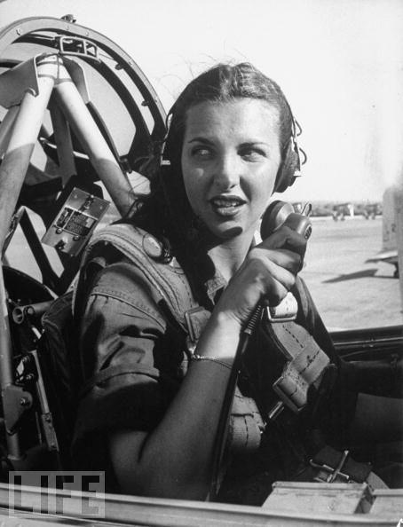 #40 Nancy Nesbit, a pilot trainee in the Women’s Flying Training Detachment checks with the control tower from the cockpit of her single engine Army trainer at Avenger Field in Texas.