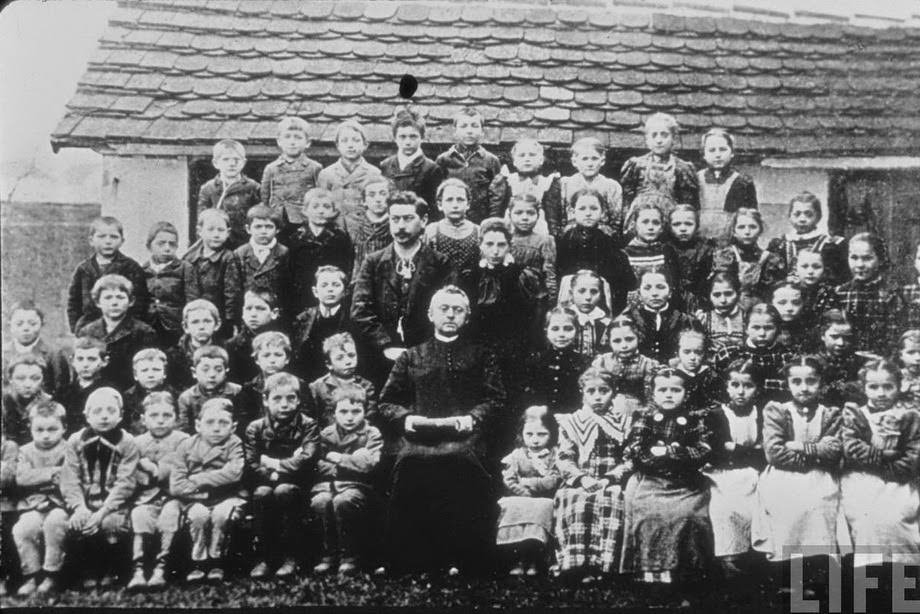 #12 Little Hitler (third from the left on the bottom row) with classmates, Fischlham, Austria-Hungary, 1895