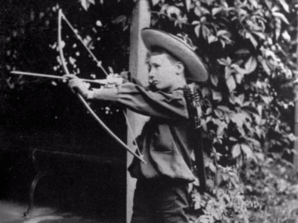 #16 Franklin D. Roosevelt with a bow and arrow, 1890