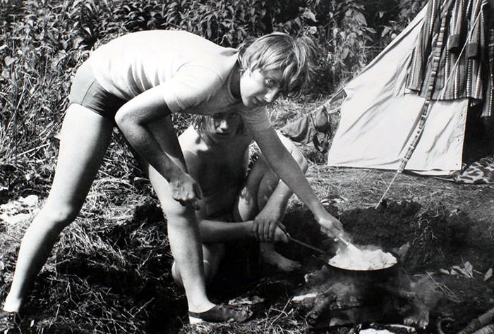 #19 Angela Merkel prepares a mean on campfire, 1973