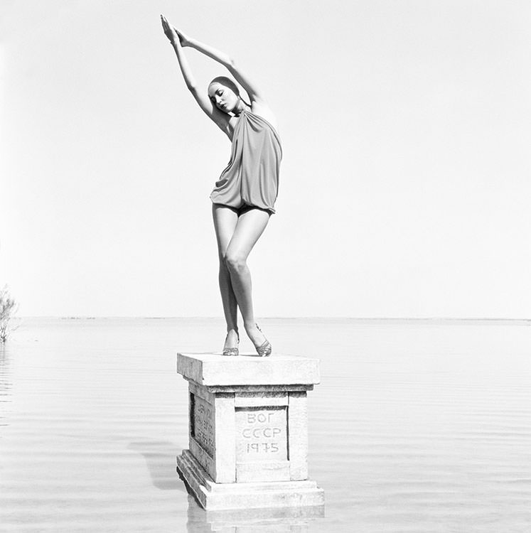 #20 Jerry Hall poses on a plinth on the shore of Lake Sevan in Armenia, 1975
