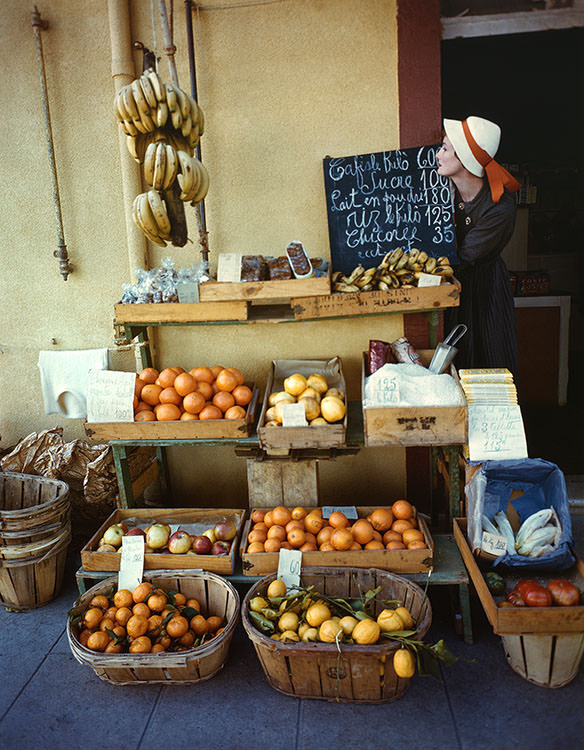 #19 Wenda Parkinson poses at a fruit stall in the South of France, 1949
