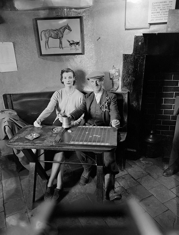 #47 Wenda Parkinson wearing a cashmere twin-set from Women’s Home Industries. In the public bar at Hobnails Inn, Little Washbourne, Gloucestershire, 1951