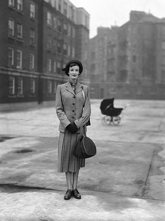 #60 Wenda Parkinson wearing a Simpson’s suit at the Peabody Trust Buildings, Fulham Road, London, 1950