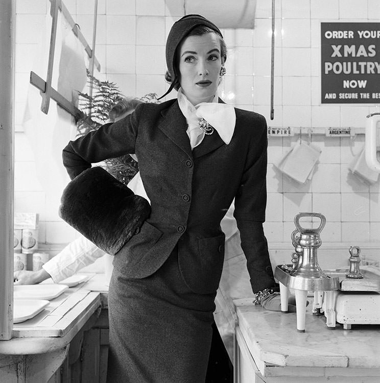 #61 Wenda Parkinson in a classic suit in clerical grey and flannel hat, 1954