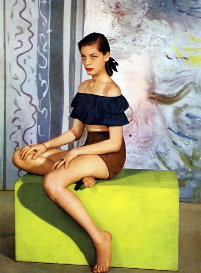 #25 Model in dove grey yoked short jacket with full sleeves by Pauline Trigère, 1945