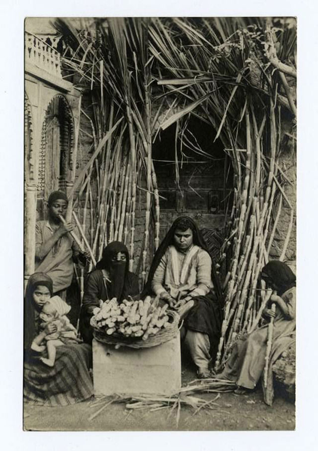 #53 Women and children preparing sugar cane