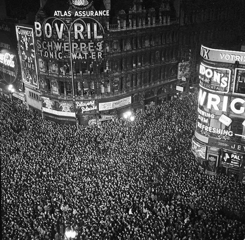 #11 Revellers cram into London’s Piccadilly Circus to count in the New Year, 1955