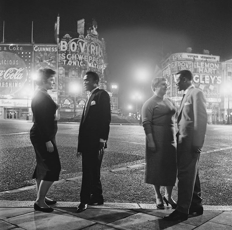#15 US troops and their girlfriends say goodbye in Piccadilly Circus after leaving the Club Americana, a Saturday night jazz club open from midnight until 7am, 1955