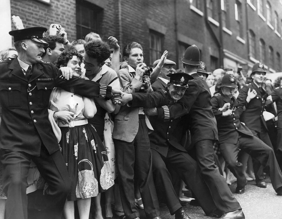 #22 Policemen try to control fans of the rock and roll singer, Tommy Steele, outside Saint Patrick’s Church on Soho Square, where he is to be married to Ann Donoghue, 1960