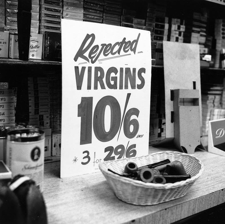 #28 A sign offering a brand of briar pipes for sale at a reduced rate is seen at Coleman Cohen tobacco shop in Old Compton Street, 1966