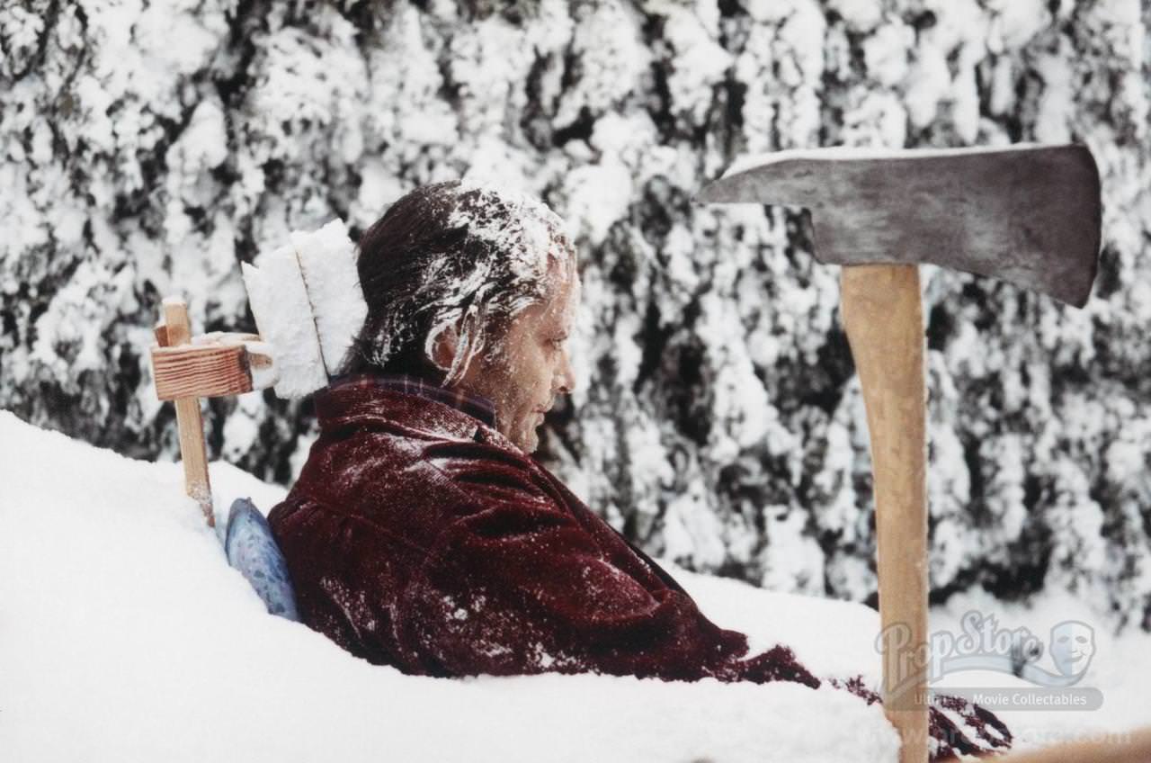 #44 Jack Nicholson posing for his final moment frozen in the snow. This side angle reveals the crude bracing system of wood and styrofoam that was built to hold Nicholson as still as possible for the lengthy shot.