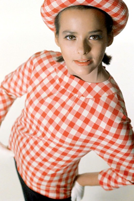 #44 Model wearing red and white checked blouse over navy shift, 1964