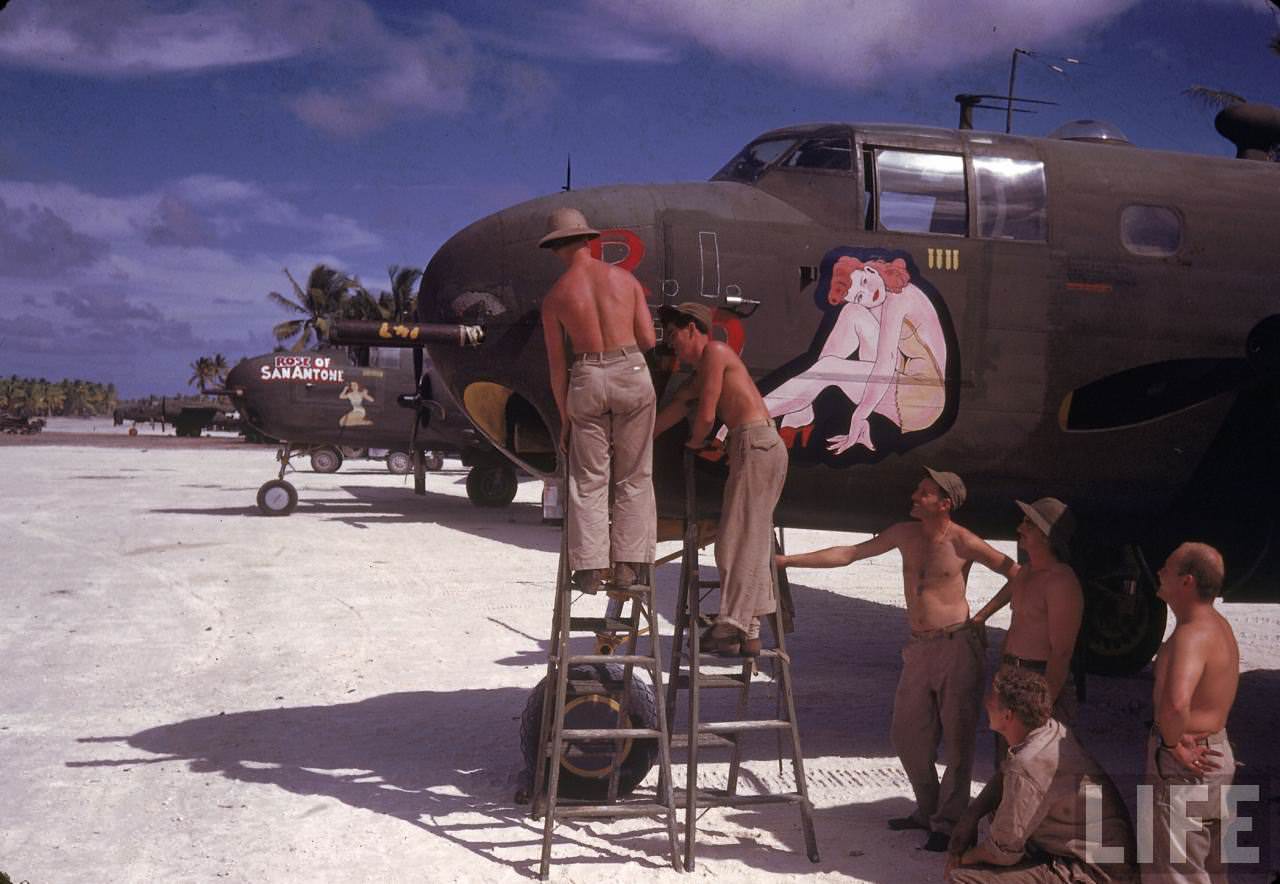 #13 American ground crew doing maintenance work on a bomber during WWII.