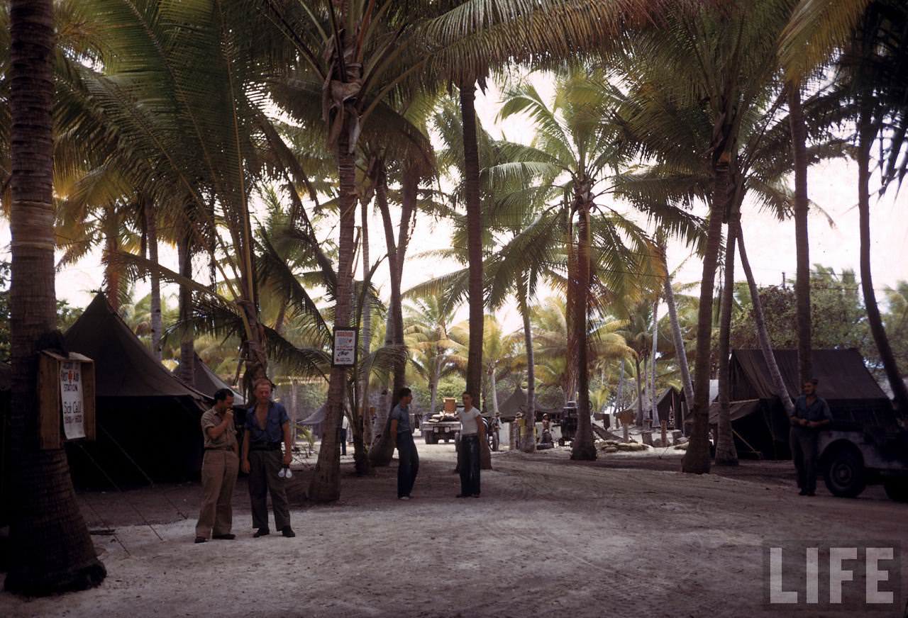 #23 Natives carrying boxes at an American island base during WWII.