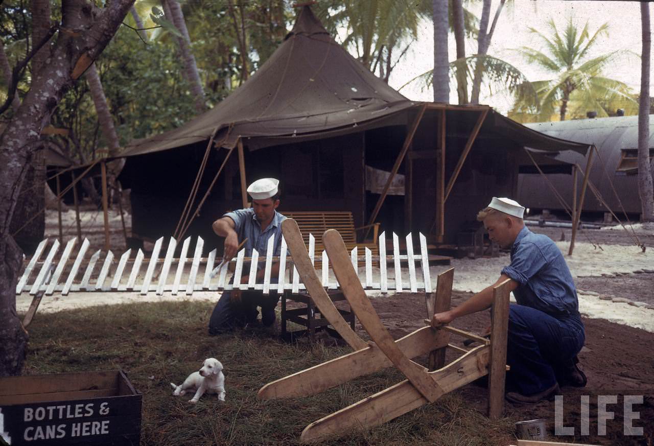 #3 American sailors building furniture and a white picket fence on Tarawa during WWII.