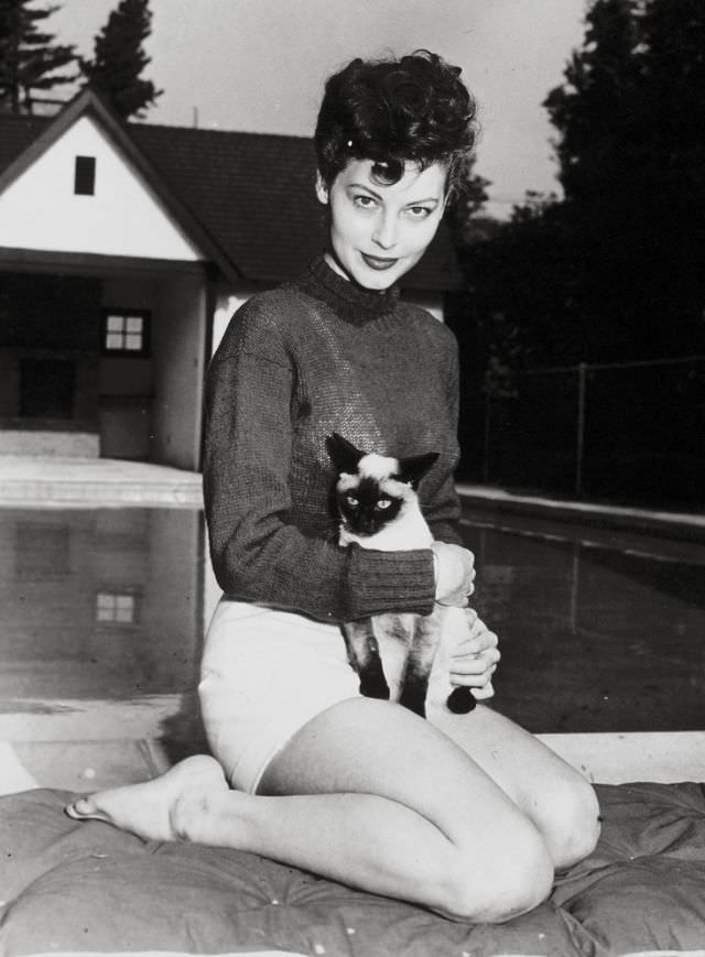 #1 Ava Gardner holding her Siamese cat, 1946