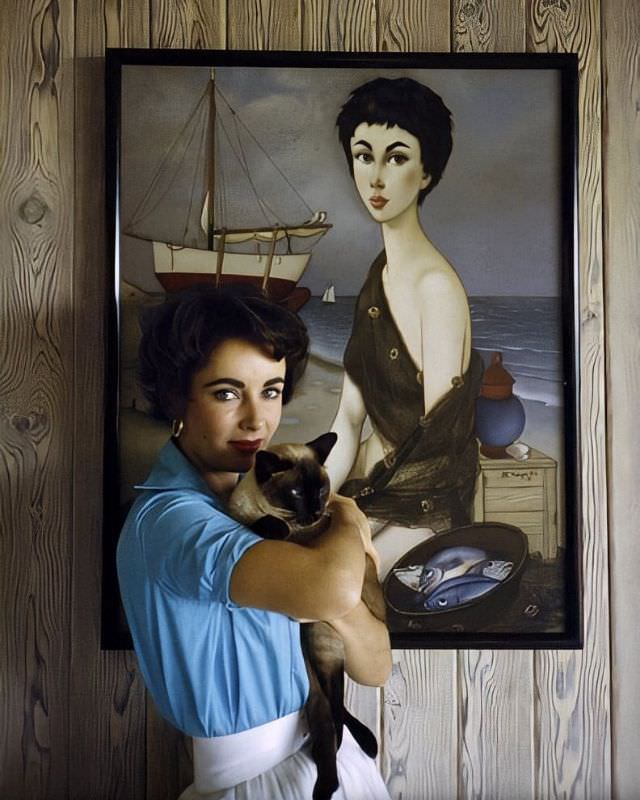 #8 Elizabeth Taylor at her Beverly Hills home with her pet Siamese cat, ‘Coffee,’ 1956